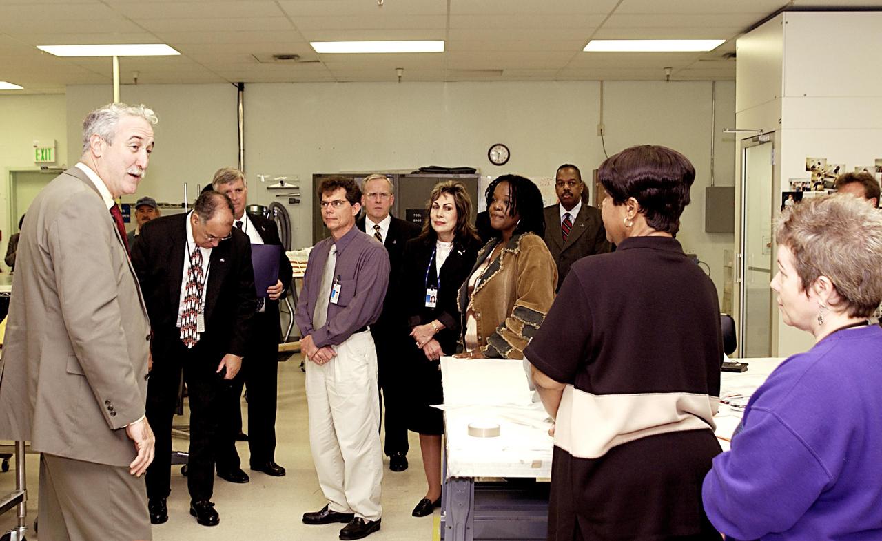 KENNEDY SPACE CENTER, FLA. -- NASA Administrator Sean O'Keefe (left) speaks to workers in the Thermal Protection System Facility. O'Keefe is visiting the site to learn more about the TPS products and process in protecting orbiters from the intense heat of launch and re-entry.  TPS tiles have been discussed in the investigation into the Columbia tragedy that destroyed the orbiter and claimed the lives of seven astronauts.
