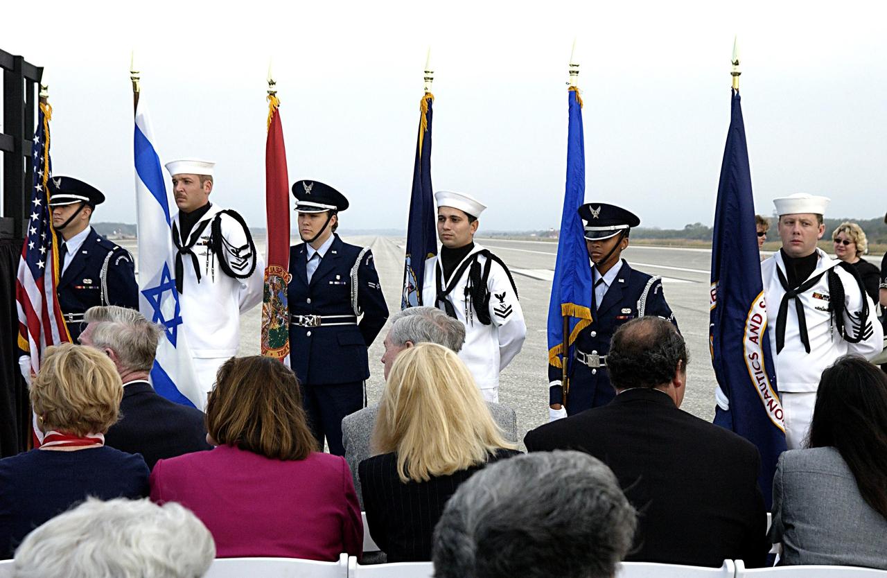 KENNEDY SPACE CENTER, FLA. --  The Patrick Air Force Base Honor Guard stands at attention during "Taps" at the conclusion of the STS-107 Columbia Crew Memorial Service held at KSC. The crew were lost on Feb. 1, 2003, over East Texas as they returned to Earth after the 16-day research mission STS-107.  Also taking part in the service were NASA Administrator Sean O'Keefe, former KSC Director Robert Crippen, astronaut Jim Halsell, several employees and area clergymen.  Crippen was the first to fly Columbia in 1981; Halsell first flew Columbia in 1994 and again in 1997.