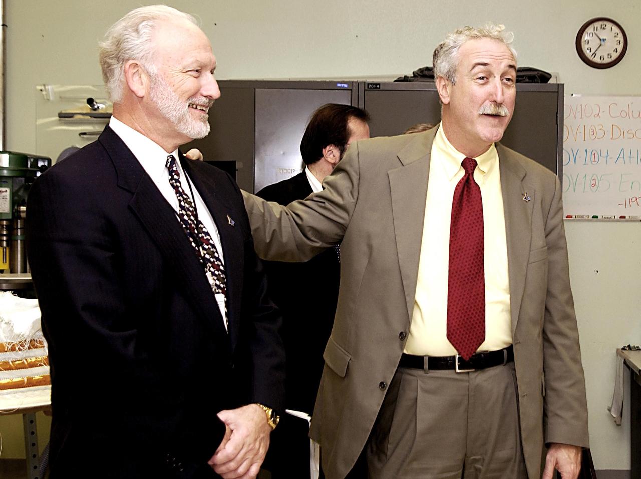 KENNEDY SPACE CENTER, FLA. -- NASA Administrator Sean O'Keefe (right) visits the Thermal Protection System Facility.  At left is Chuck Fontana, associate program manager, Integrated Logistics. O'Keefe is visiting the site to learn more about the TPS products and process in protecting orbiters from the intense heat of launch and re-entry.  TPS tiles have been discussed in the investigation into the Columbia tragedy that destroyed the orbiter and claimed the lives of seven astronauts..