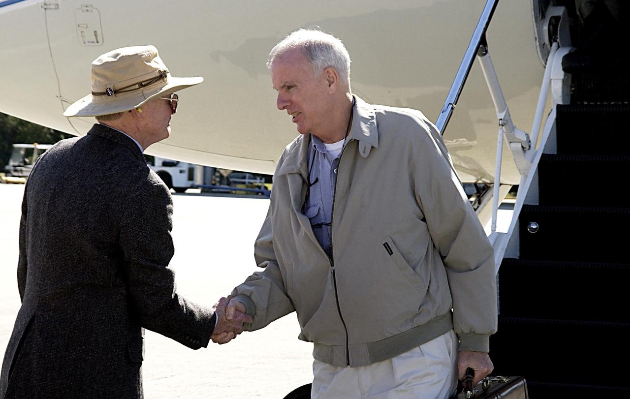 KENNEDY SPACE CENTER, FLA. - Center Director Roy Bridges (left) greets Retired Navy Admiral Harold W. Gehman Jr., chairman of the Columbia Accident Board, after his arrival at the KSC Shuttle Landing Facility.   Gehman and other members of the board are visiting sites at KSC to become familiar with the Shuttle launch process. The independent board is charged with determining what caused the destruction of the Space Shuttle Columbia and the loss of its seven-member crew on Feb. 1 during reentry.