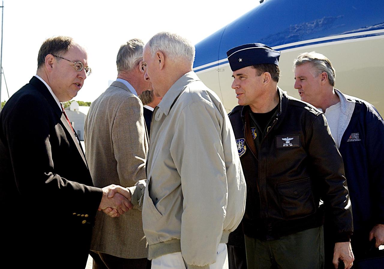 KENNEDY SPACE CENTER, FLA. - At the KSC Shuttle Landing Facility Wayne Hale, manager of Space Shuttle Program Launch Integration. greets Retired Navy Admiral Harold W. Gehman Jr., chairman of the Columbia Accident Board, after his arrival at the KSC Shuttle Landing Facility.   Gehman and other members of the board (behind Gehman) are visiting sites at KSC to become familiar with the Shuttle launch process. The independent board is charged with determining what caused the destruction of the Space Shuttle Columbia and the loss of its seven-member crew on Feb. 1 during reentry.