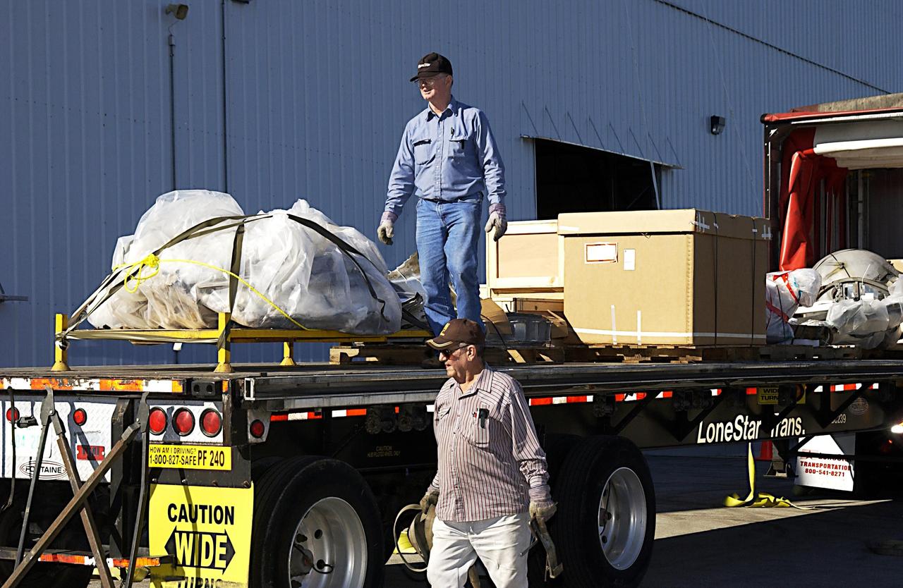 KENNEDY SPACE CENTER, FLA. --  With the protective cover removed from the truck, workers at the RLV Hangar near the Shuttle Landing Facility are able to offload recovered Columbia debris transported from the collection point at Barksdale Air Force Base, Shreveport, La.  Workers in the RLV will attempt to reconstruct the orbiter as part of the ongoing investigation of the accident that destroyed the Columbia and claimed the lives of seven astronauts as they returned to Earth after a 16-day research mission, STS-107.