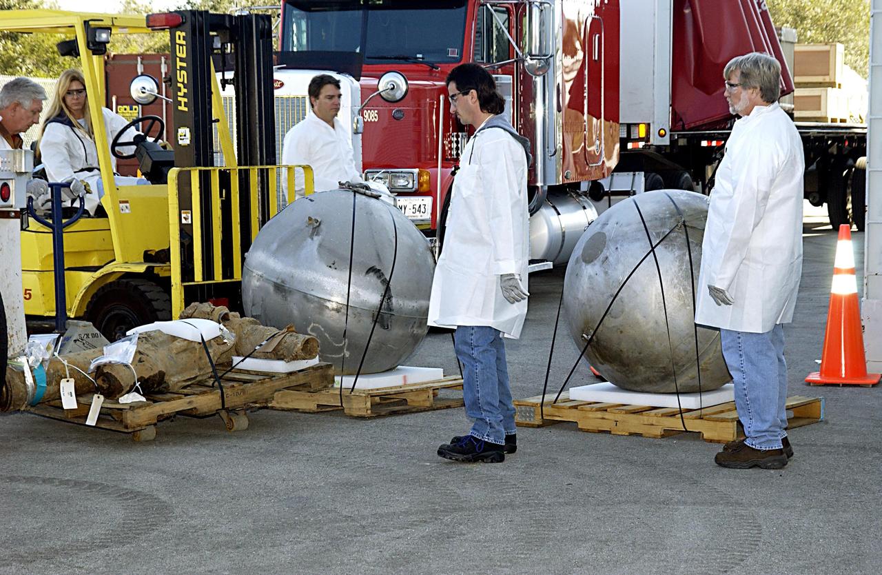 KENNEDY SPACE CENTER, FLA. -- Several more pieces of debris are moved into the RLV Hangar near the Shuttle Landing Facility. Truckloads of the debris arrived from the collection point at Barksdale Air Force Base, Shreveport, La. The workers will attempt to reconstruct the orbiter as part of the ongoing investigation of the accident that destroyed the Columbia and claimed the lives of seven astronauts as they returned to Earth after a 16-day research mission, STS-107.