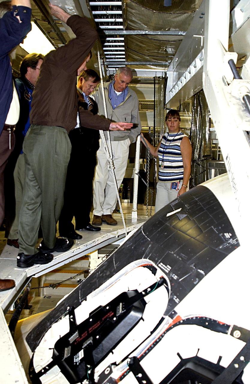 KENNEDY SPACE CENTER, FLA. - Retired Navy Admiral Harold W. Gehman Jr. (second from right), chairman of the Columbia Accident Investigation Board, and other members of the board are given a guided tour around Space Shuttle Endeavour by the Orbiter Processing Facility manager. Gehman and other members of the board are visiting sites at KSC to become familiar with the Shuttle launch process. The independent board is charged with determining what caused the destruction of the Space Shuttle Columbia and the loss of its seven-member crew on Feb. 1 during reentry.