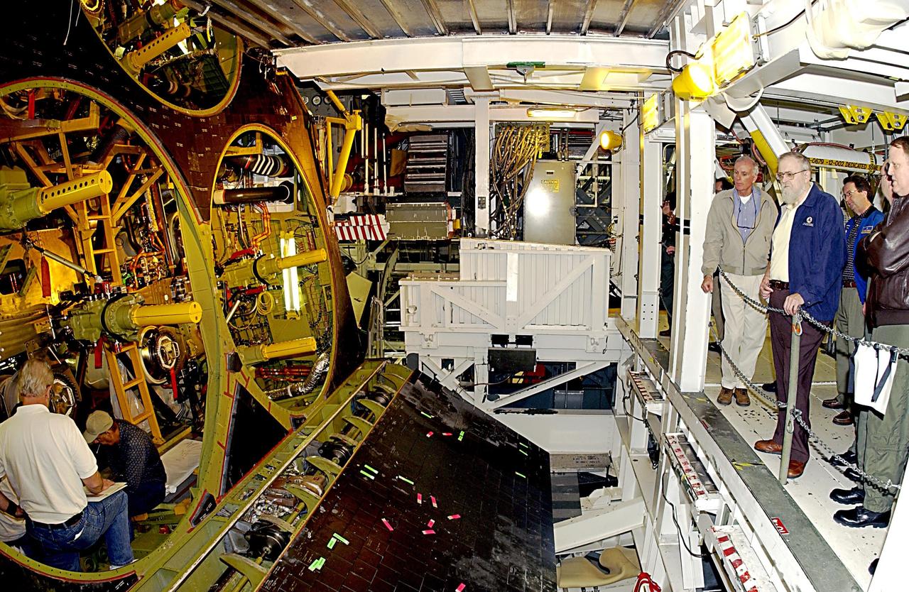 KENNEDY SPACE CENTER, FLA. - Retired Navy Admiral Harold W. Gehman Jr. (fourth from right), chairman of the Columbia Accident Investigation Board, and other members of the board are given a guided tour around Space Shuttle Endeavour as it undergoes processing in an Orbiter Processing Facility bay. Gehman and other members of the board are visiting sites at KSC to become familiar with the Shuttle launch process. The independent board is charged with determining what caused the destruction of the Space Shuttle Columbia and the loss of its seven-member crew on Feb. 1 during reentry.