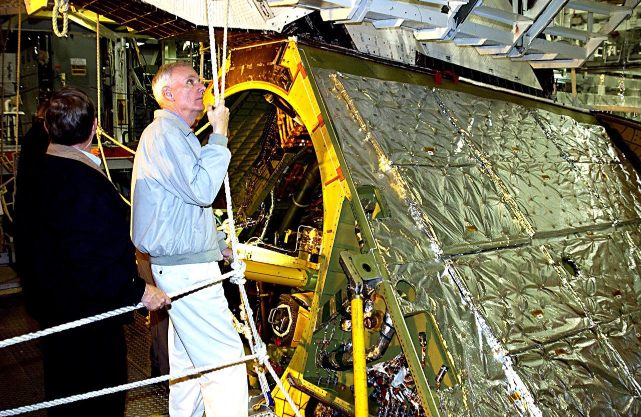 KENNEDY SPACE CENTER, FLA. - Retired Navy Admiral Harold W. Gehman Jr. (right), chairman of the Columbia Accident Investigation Board, and other members of the board are given a guided tour around Space Shuttle Endeavour as it undergoes processing in an Orbiter Processing Facility bay. Gehman and other members of the board are visiting sites at KSC to become familiar with the Shuttle launch process. The independent board is charged with determining what caused the destruction of the Space Shuttle Columbia and the loss of its seven-member crew on Feb. 1 during reentry.