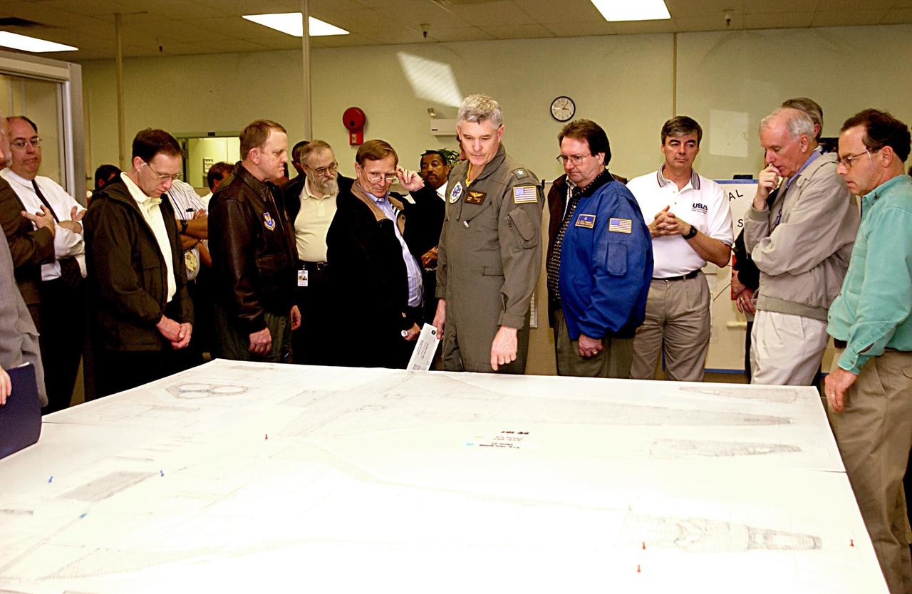 KENNEDY SPACE CENTER, FLA. - Retired Navy Admiral Harold W. Gehman Jr. (second from right), chairman of the Columbia Accident Investigation Board, and other members of the board study a diagram of a Space Shuttle orbiter. Gehman and other members of the board are visiting sites at KSC to become familiar with the Shuttle launch process. The independent board is charged with determining what caused the destruction of the Space Shuttle Columbia and the loss of its seven-member crew on Feb. 1 during reentry.