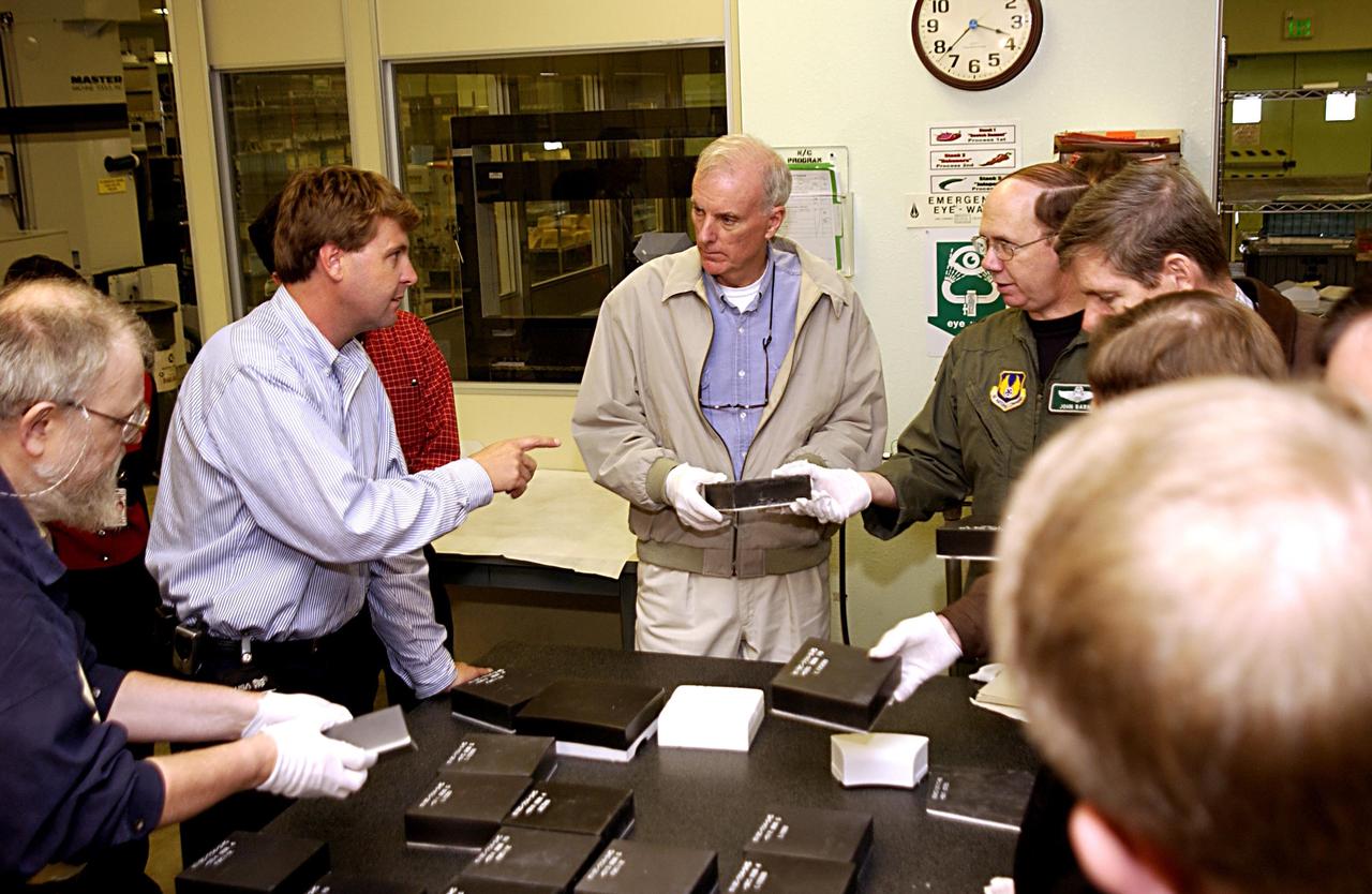 KENNEDY SPACE CENTER, FLA. - Retired Navy Admiral Harold W. Gehman Jr. (center), chairman of the Columbia Accident Investigation Board, visits the Thermal Protection System shop and is briefed by Martin Wilson (pointing), the shop manager. Gehman and other members of the board are visiting sites at KSC to become familiar with the Shuttle launch process. The independent board is charged with determining what caused the destruction of the Space Shuttle Columbia and the loss of its seven-member crew on Feb. 1 during reentry.