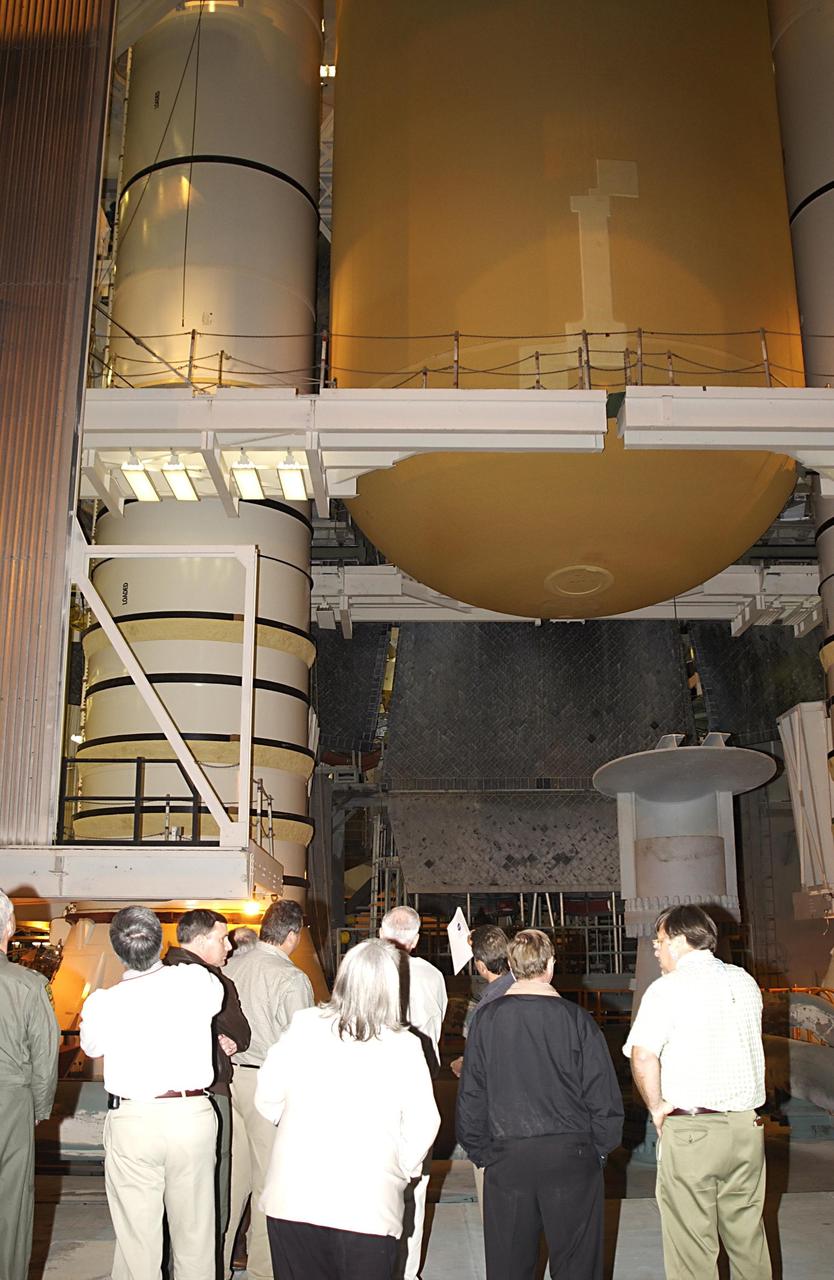 KENNEDY SPACE CENTER, FLA. -- In the Vehicle Assembly Building, the Columbia Accident Investigation Board looks at the solid rocket booster and external tank mated with Space Shuttle Atlantis. The board is visiting sites at KSC to become familiar with the Shuttle launch process and elements. The independent board is charged with determining what caused the destruction of the Space Shuttle Columbia and the loss of its seven-member crew on Feb. 1 during reentry.