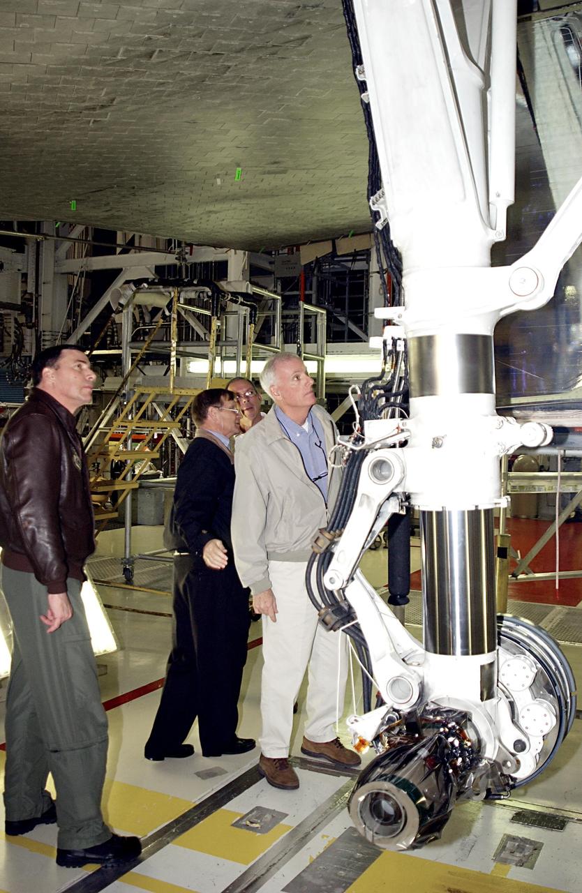 KENNEDY SPACE CENTER, FLA. -- Members of the Columbia Accident Investigation Board look at areas of interest on Space Shuttle Endeavour. In the center is Retired Navy Adm. Harold Gehman Jr., who is chairman of the board, looking up at the underside of Endeavour The board is visiting sites at KSC to become familiar with the Shuttle launch process and elements. The independent board is charged with determining what caused the destruction of the Space Shuttle Columbia and the loss of its seven-member crew on Feb. 1 during reentry.