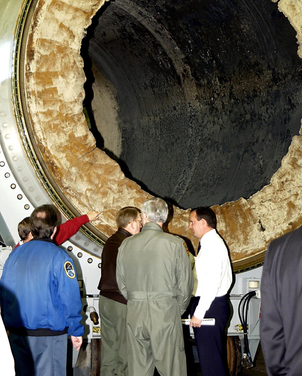 KENNEDY SPACE CENTER, FLA. -- Members of the Columbia Accident Investigation Board look at a segment of a solid rocket booster in Hangar AF (the SRB Disassembly Facility). The board is visiting sites at KSC to become familiar with the Shuttle launch process and elements. The independent board is charged with determining what caused the destruction of the Space Shuttle Columbia and the loss of its seven-member crew on Feb. 1 during reentry.