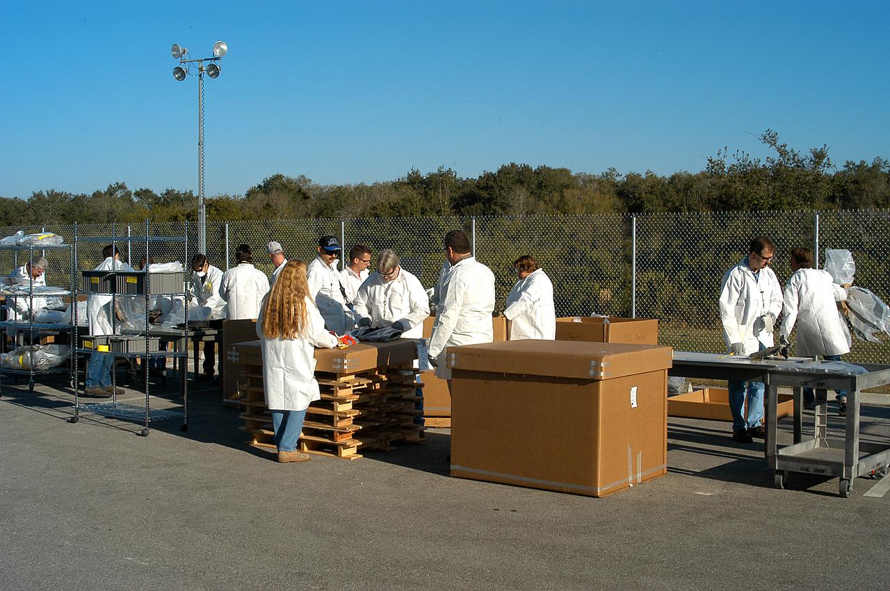 The reconstruction team checks out the Columbia debris after it was offloaded at the RLV Hangar. The debris was shipped from Barksdale Air Force Base, Shreveport, La. As part of the ongoing investigation into the tragic accident, workers will attempt to reconstruct the orbiter inside the RLV. 