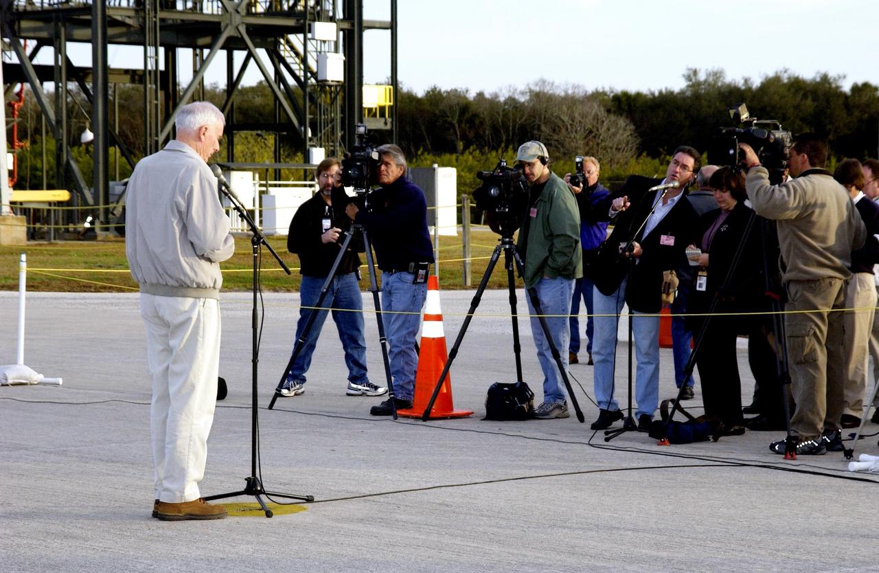 KENNEDY SPACE CENTER, FLA. --  Retired Navy Admiral Harold W. Gehman Jr. (left), chairman of the Columbia Accident Investigation Board, addresses the press at the Shuttle Landing Facility before departing KSC. Gehman and other members of the board visited sites at KSC to become familiar with Shuttle processing procedures. The independent board is charged with determining what caused the destruction of the Space Shuttle Columbia and the loss of its seven-member crew on Feb. 1 during reentry.