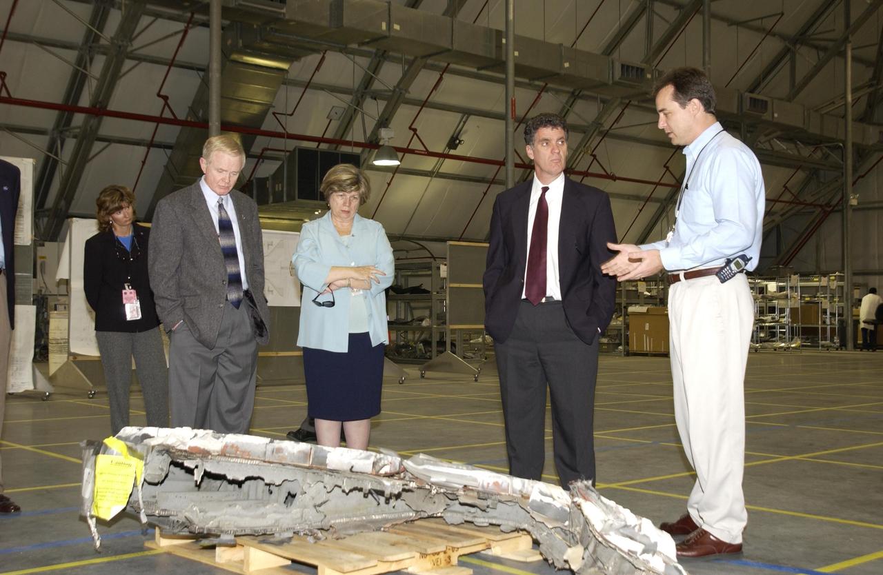 KENNEDY SPACE CENTER, FLA. -- Congressman Dave Weldon (second from right) looks over the pieces of Columbia debris stored in the RLV Hangar.  At right is Steve Altemus, Space Shuttle test director.  Accompanying Weldon are (from left) Center Director Roy Bridges and External Relations and Business Development Director JoAnn Morgan. Workers will attempt to reconstruct the orbiter as part of the ongoing investigation of the accident that destroyed the Columbia and claimed the lives of seven astronauts as they returned to Earth after a 16-day research mission, STS-107.