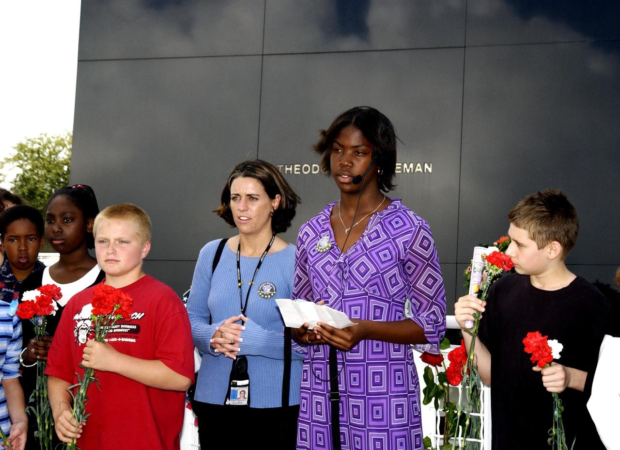 KENNEDY SPACE CENTER, FLA. -  At the KSC Visitor Complex Astronaut Memorial, Jasmine Haralson (second from right), a student from Columbia Elementary School in Palm Bay, Fla., recites during a tribute to the fallen crew of Space Shuttle Columbia. She and other students from the elementary school visited the Center to learn about the past, present and future of space exploration.  They also listened to Kirstie McCool Chadwick, the sister of Columbia astronaut William "Willie" J. McCool, and saw the 3-D IMAX film "Space Station."