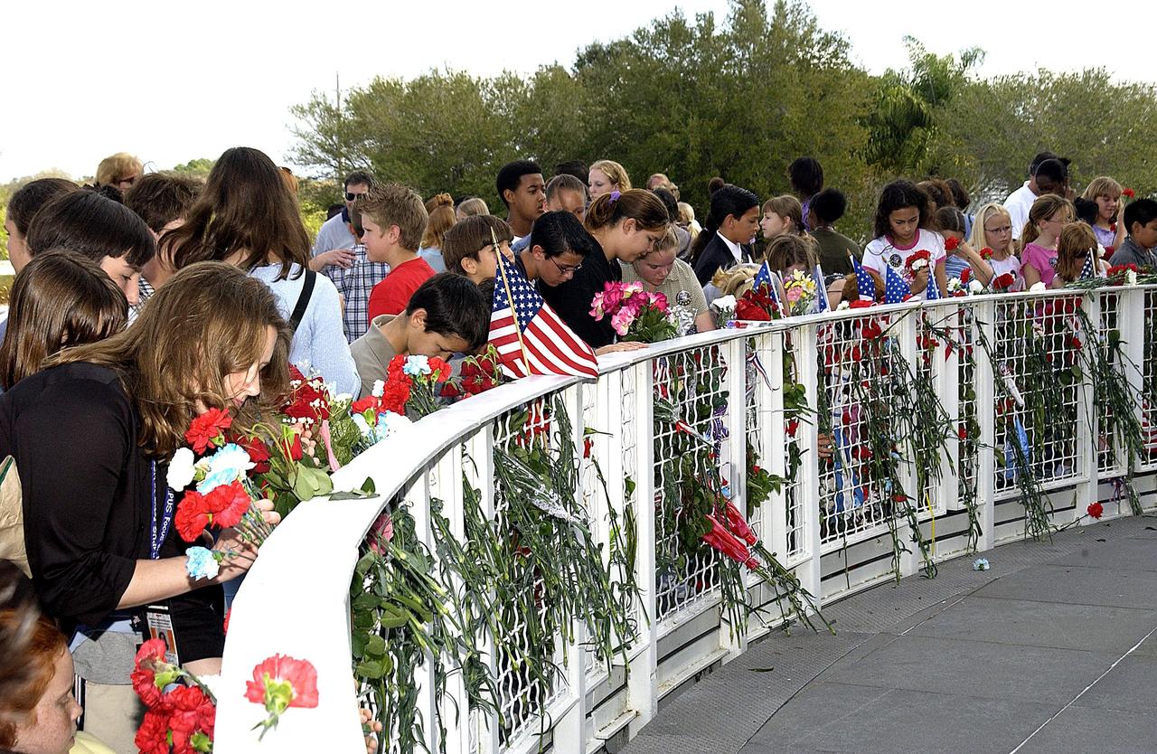 KENNEDY SPACE CENTER, FLA. -- Students from Columbia Elementary School in Palm Bay, Fla., place flowers at the Astronaut Memorial to honor the fallen crew of Space Shuttle Columbia. The students visited the Center to learn about the past, present and future of space exploration.  They also listened to Kirstie McCool Chadwick, the sister of Columbia astronaut William "Willie" J. McCool, and saw the 3-D IMAX film "Space Station."