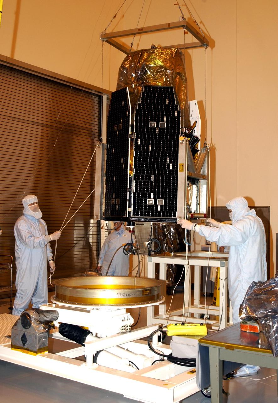 KENNEDY SPACE CENTER, FLA. -- The GALEX satellite is rotated to vertical again for solar array testing in the Multi-Payload Processing Facility. The Galaxy Evolution Explorer (GALEX) is an orbiting space telescope that will observe galaxies in ultraviolet light across 10 billion years of cosmic history. Led by the California Institute of Technology, GALEX will conduct several first-of-a-kind sky surveys, including an extra-galactic (beyond our galaxy) ultraviolet all-sky survey. During its 29-month mission GALEX will produce the first comprehensive map of a Universe of galaxies under construction, bringing more understanding of how galaxies like the Milky Way were formed. GALEX is due to be launched from Cape Canaveral Air Force Station March 25 via a Pegasus rocket.