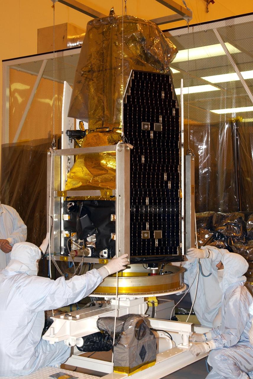 KENNEDY SPACE CENTER, FLA. - Workers prepare the GALEX satellite for solar array testing in the Multi-Payload Processing Facility. The Galaxy Evolution Explorer (GALEX) is an orbiting space telescope that will observe galaxies in ultraviolet light across 10 billion years of cosmic history. Led by the California Institute of Technology, GALEX will conduct several first-of-a-kind sky surveys, including an extra-galactic (beyond our galaxy) ultraviolet all-sky survey. During its 29-month mission GALEX will produce the first comprehensive map of a Universe of galaxies under construction, bringing more understanding of how galaxies like the Milky Way were formed. GALEX is due to be launched from Cape Canaveral Air Force Station March 25 via a Pegasus rocket.