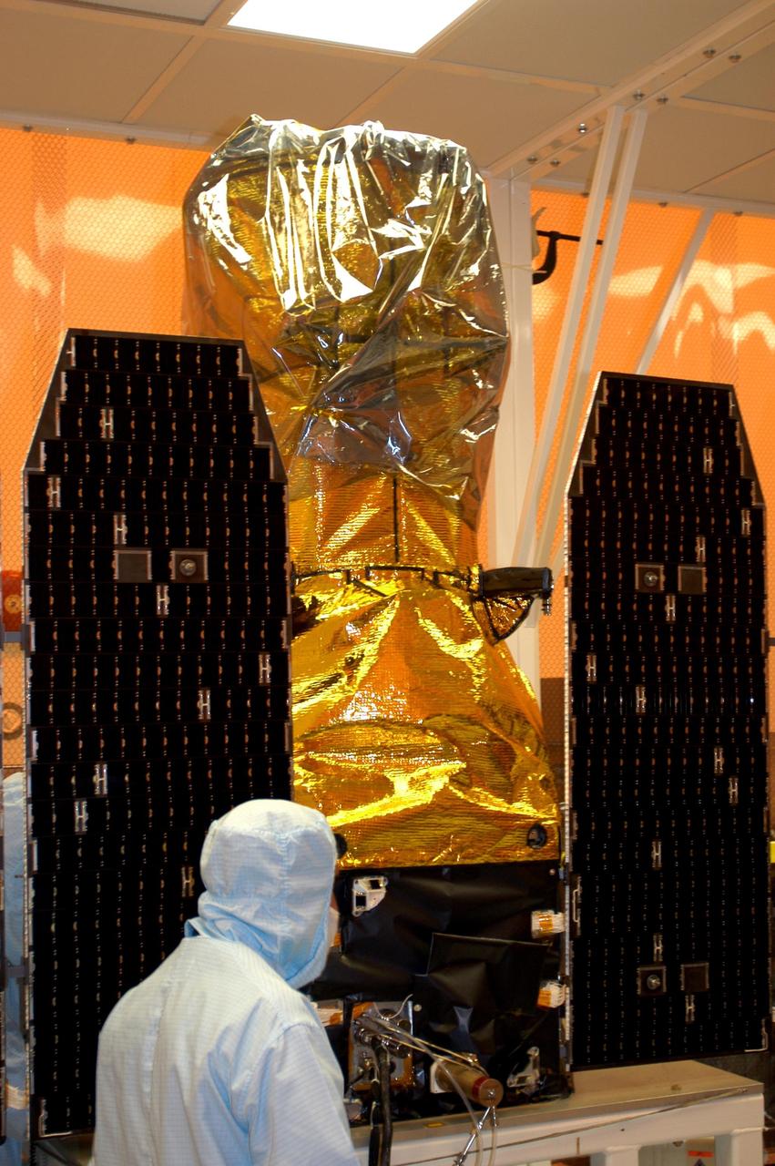 KENNEDY SPACE CENTER, FLA. -- The solar array panels on the Galaxy Evolution Explorer (GALEX) satellite are deployed during processing in the Multi-Payload Processing Facility. The GALEX is an orbiting space telescope that will observe galaxies in ultraviolet light across 10 billion years of cosmic history. Led by the California Institute of Technology, GALEX will conduct several first-of-a-kind sky surveys, including an extra-galactic (beyond our galaxy) ultraviolet all-sky survey. During its 29-month mission GALEX will produce the first comprehensive map of a Universe of galaxies under construction, bringing more understanding of how galaxies like the Milky Way were formed.  GALEX is due to be launched from Cape Canaveral Air Force Station March 25 via a Pegasus rocket.