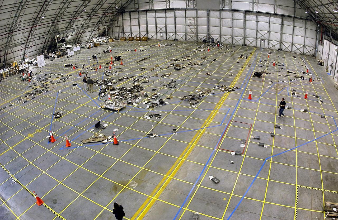 KENNEDY SPACE CENTER, FLA. --  A long view inside the RLV Hangar shows the grid on the floor and placement of some of the debris from Columbia. Workers are attempting to reconstruct the orbiter inside the hangar as part of the ongoing investigation into the tragic accident that claimed Columbia and her crew of seven returning from mission STS-107.