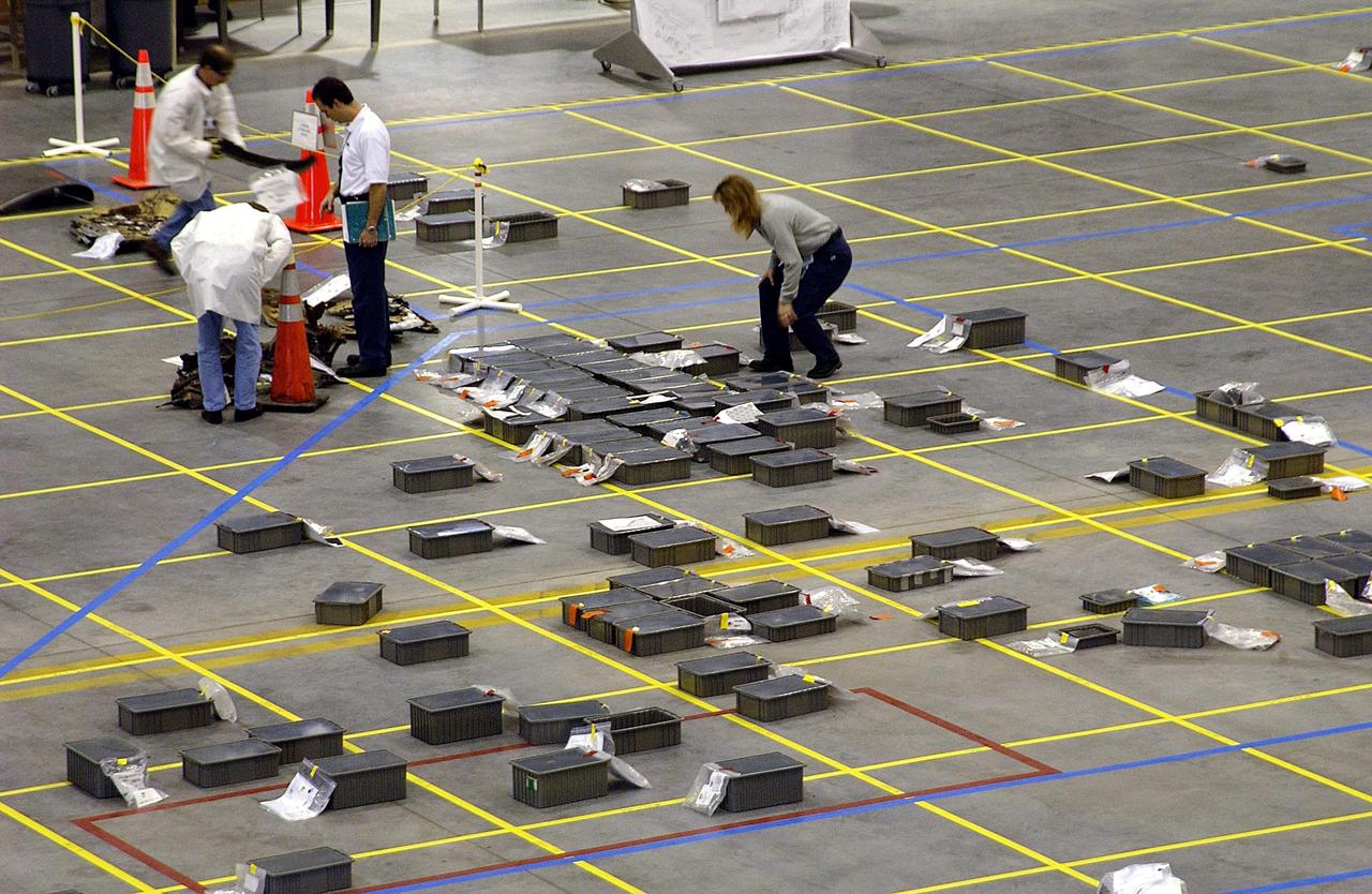 KENNEDY SPACE CENTER, FLA. - This view inside the RLV Hangar at KSC shows the grid on the floor and placement of some of the debris from Columbia. Workers are attempting to reconstruct the orbiter inside the hangar as part of the ongoing investigation into the tragic accident that claimed Columbia and her crew of seven returning from mission STS-107.