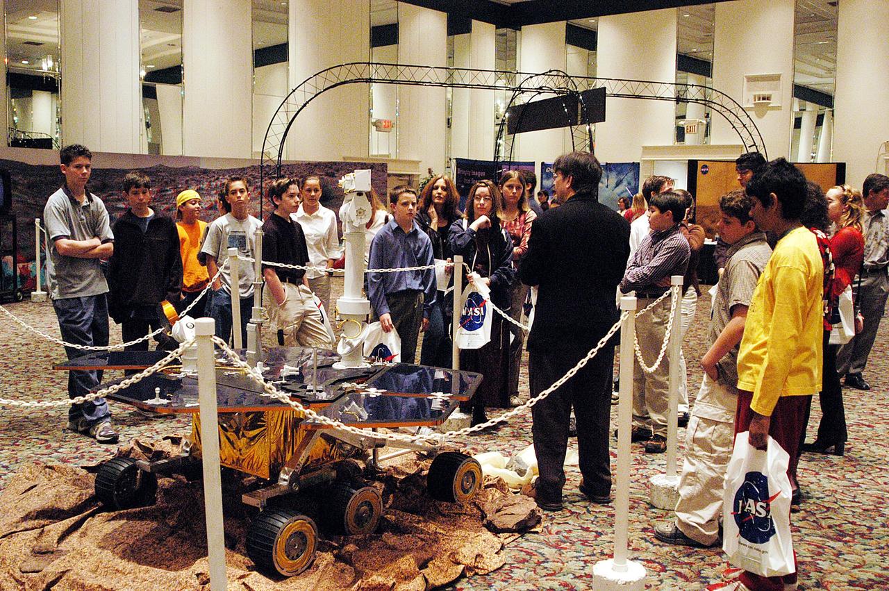 KENNEDY SPACE CENTER, FLA. - At NASA's Family & Community Mars Exploration Day, held in Cape Canaveral, Fla., James Garvin, lead scientist for the Mars Exploration Program, talks to students about the Mars Exploration Rover. Garvin is standing next to a replica of the Rover. The event informed students and the general public about Florida's key role as NASA's "Gateway to Mars" and offered an opportunity to meet with scientists, engineers, educators and others working Mars exploration missions. The Mars Exploration Rovers are being prepared for launch this spring aboard Boeing Delta II rockets from the Cape Canaveral Air Force Station. They will land on Mars and start exploring in January 2004.