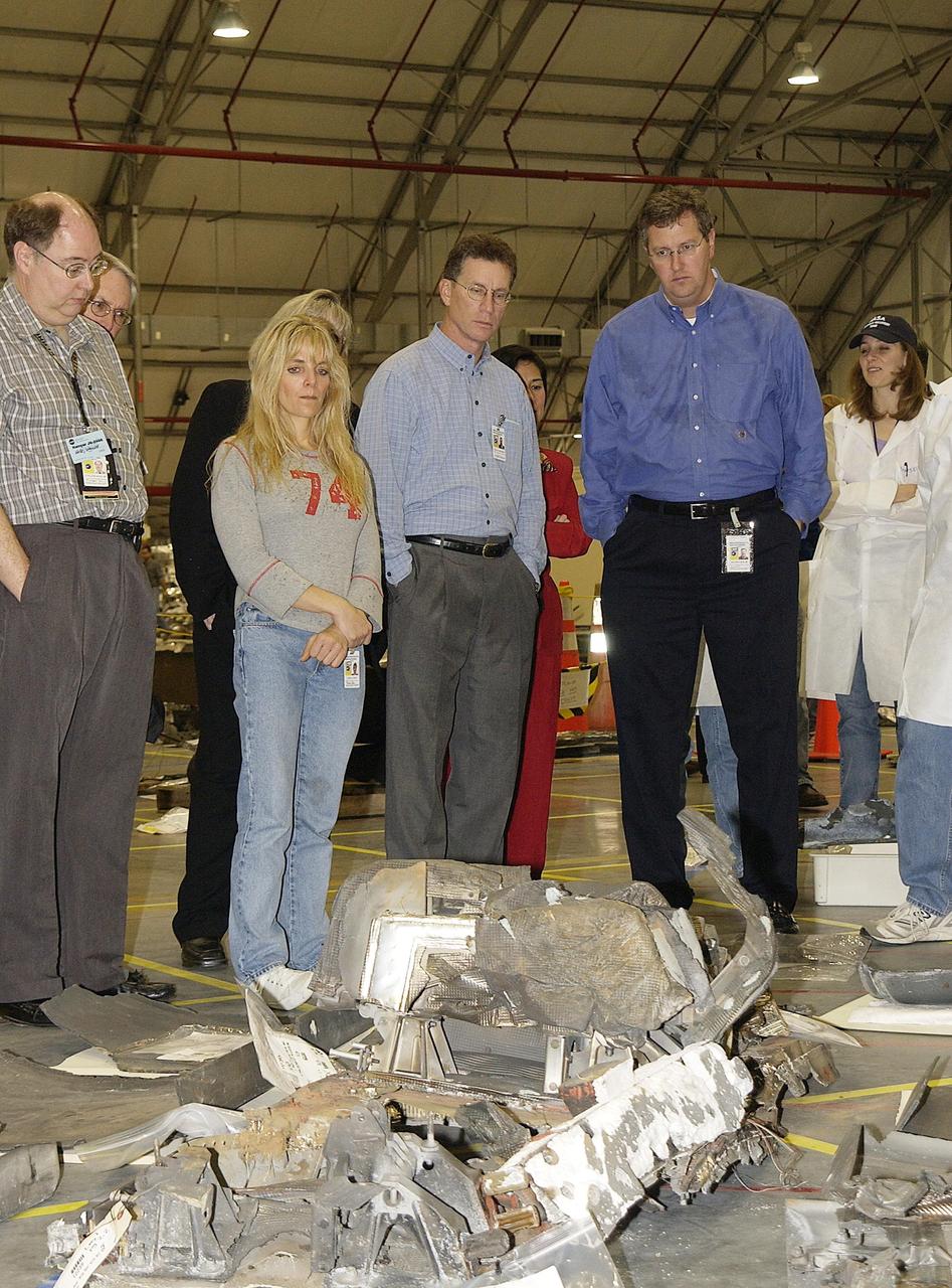 KENNEDY SPACE CENTER, FLA. -- Ralph Roe (second from right), with the Orbiter Work Group, JSC, and Shuttle Program Manager Ron Dittemore (third from right) look at Columbia debris in the RLV Hangar at KSC. The Columbia Restoration Project Team is examining pieces and attempting to reconstruct the orbiter as part of the investigation into the accident that caused the destruction of Columbia on its return to Earth from mission STS-107. To date, four shipments have arrived from Barksdale AFB, Shreveport, La., the collection point for debris.