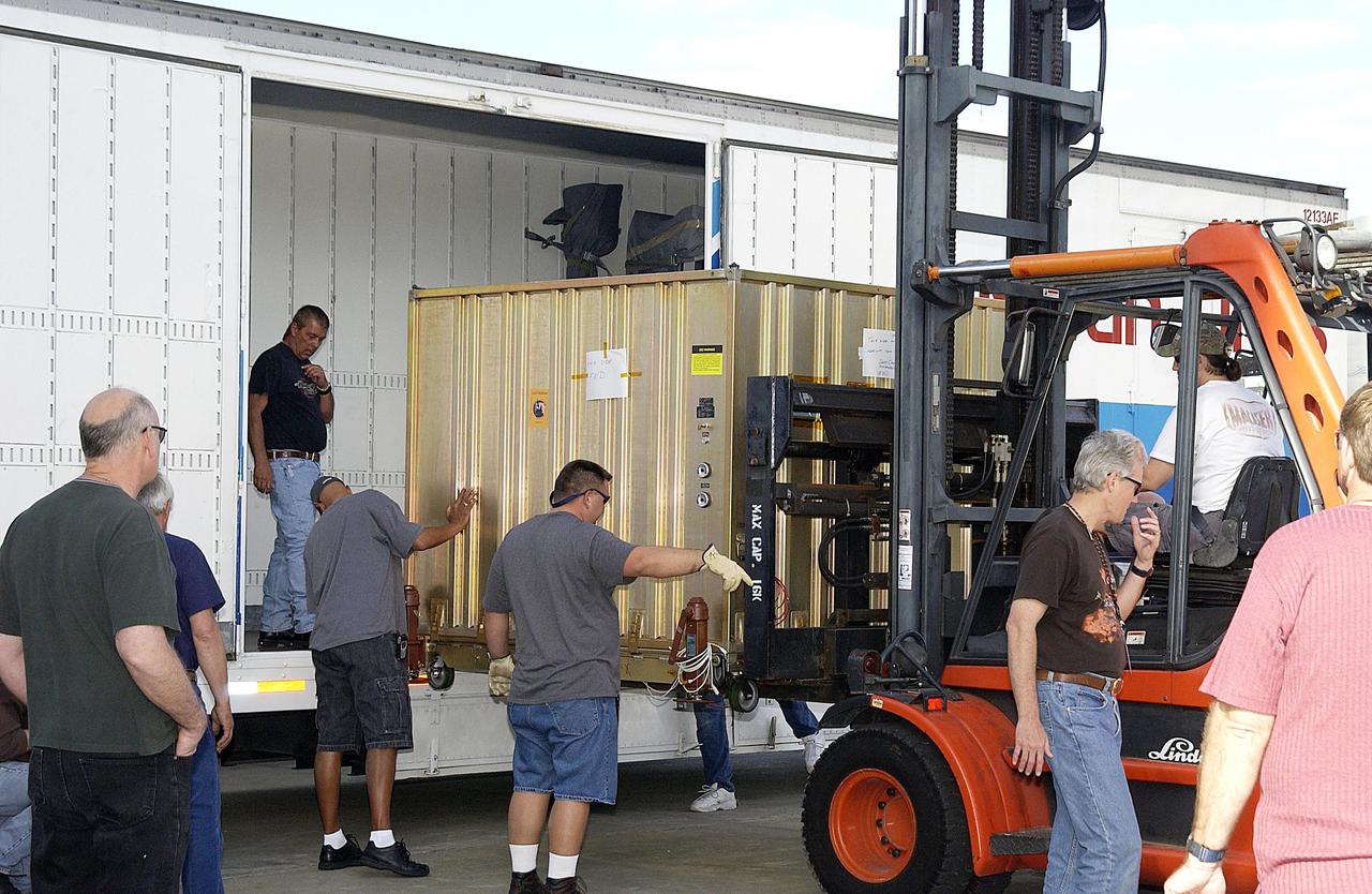 KENNEDY SPACE CENTER, FLA. -  The aeroshell for the Mars Exploration Rover-1 mission is offloaded at KSC's Multi-Payload Processing Facility.  While at KSC, the rovers, aeroshells and landers will undergo a full mission simulation. All of these flight elements will then be integrated together. After spin balance testing,  each spacecraft will be mated to a solid propellant upper stage booster that will propel the spacecraft out of Earth orbit. Approximately 10 days before launch they will be transported to the launch pad for mating with their respective Boeing Delta II rockets. The rovers will serve as robotic geologists to seek answers about the evolution of Mars, particularly  for a history of water. The rovers will be identical to each other, but will land at different regions of Mars.  Launch of the MER-1 is scheduled for May 30.  MER-2 will follow June 25.