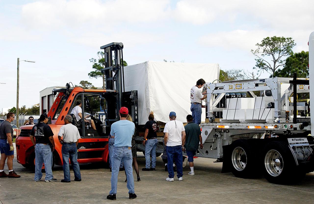 KENNEDY SPACE CENTER, FLA. --  Another component of the Mars Exploration Rover-1 mission is offloaded at KSC's Multi-Payload Processing Facility.  While at KSC, the rovers, aeroshells and landers will undergo a full mission simulation. All of these flight elements will then be integrated together. After spin balance testing,  each spacecraft will be mated to a solid propellant upper stage booster that will propel the spacecraft out of Earth orbit. Approximately 10 days before launch they will be transported to the launch pad for mating with their respective Boeing Delta II rockets. The rovers will serve as robotic geologists to seek answers about the evolution of Mars, particularly  for a history of water. The rovers will be identical to each other, but will land at different regions of Mars.  Launch of the MER-1 is scheduled for May 30.  MER-2 will follow June 25.