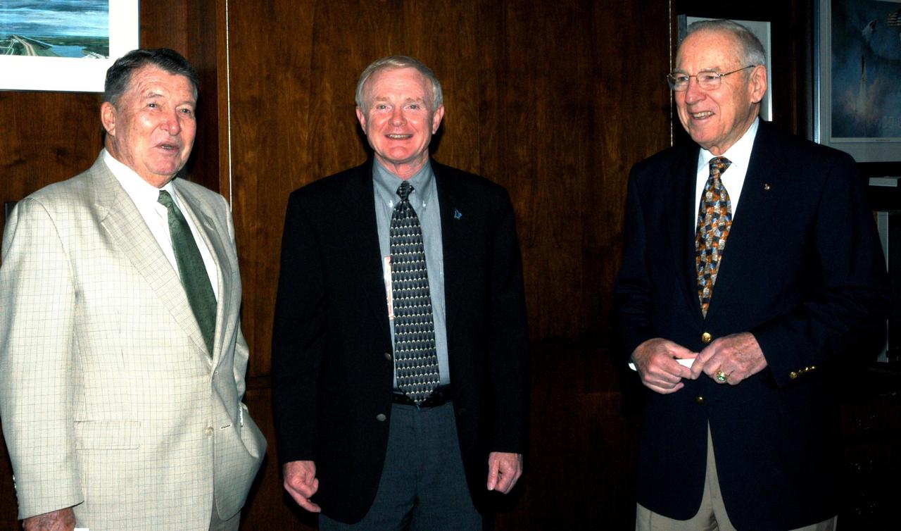 KENNEDY SPACE CENTER, FLA. - Former astronauts Wally Schirra (left) and Jim Lovell (right) join Center Director Roy Bridges (center) before a presentation to KSC employees. Lovell and Schirra visited KSC to talk about the space program and their experiences, as well as offer encouragement to workers to help get the space program "back on its feet."  They visited several sites around the Center, including the RLV Hangar where Columbia debris is being collected and examined as part of the investigation into the tragedy that claimed the orbiter and lives of seven astronauts returning from mission STS-107.