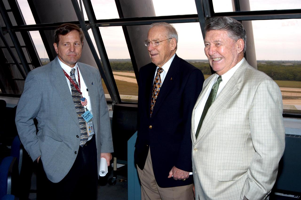 KENNEDY SPACE CENTER, FLA. - At the KSC Launch Control Complex, former astronauts Jim Lovell (center) and Wally Schirra (right) talk with Mike Wetmore, director of Shuttle Processing (left). Lovell and Schirra visited KSC to talk about the space program and their experiences, as well as offer encouragement to workers to help get the space program "back on its feet."  They visited several sites around the Center, including the RLV Hangar where Columbia debris is being collected and examined as part of the investigation into the tragedy that claimed the orbiter and lives of seven astronauts returning from mission STS-107.
