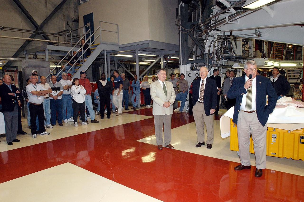KENNEDY SPACE CENTER, FLA. - In the Orbiter Processing Facility, Bill Pickavance, vice president and deputy program manager, United Space Alliance, talks to employees.  With him, at left, are former astronauts Wally Schirra and Jim Lovell.  The latter two visited several KSC sites, relating their experiences in the space program and offerking encouragement to workers to help get the space program "back on its feet." They visited several sites around the Center, including the RLV Hangar where Columbia debris is being collected and examined as part of the investigation into the tragedy that claimed the orbiter and lives of seven astronauts returning from mission STS-107.