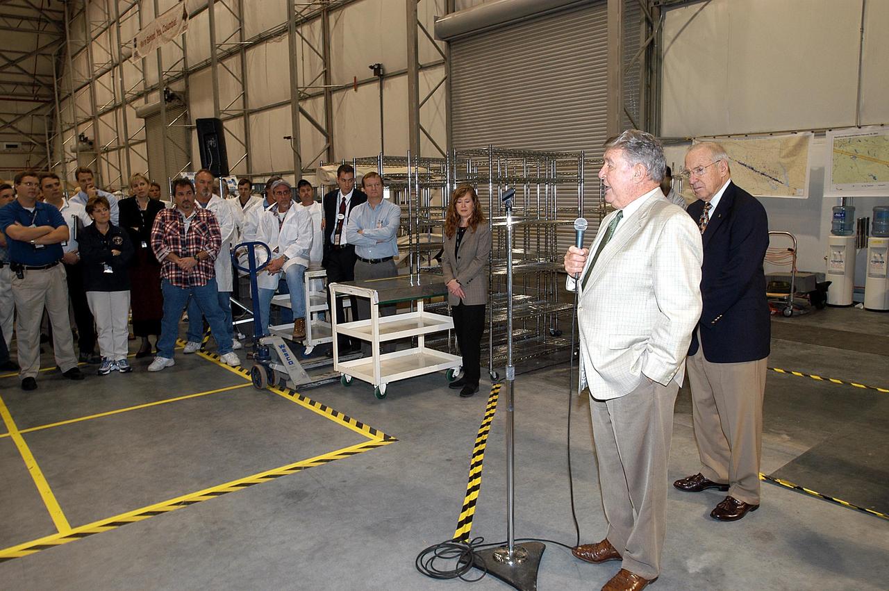 KENNEDY SPACE CENTER, FLA. -In the RLV Hangar, former astronauts Wally Schirra (right, with microphone) and Jim Lovell (far right) talk to employees and offer encouragement to help get the space program "back on its feet." The two visited several sites around the Center, encouraging workers to help get the space program "back on its feet." The RLV Hangar is where Columbia debris is being collected and examined as part of the investigation into the tragedy that claimed the orbiter and lives of seven astronauts returning from mission STS-107.