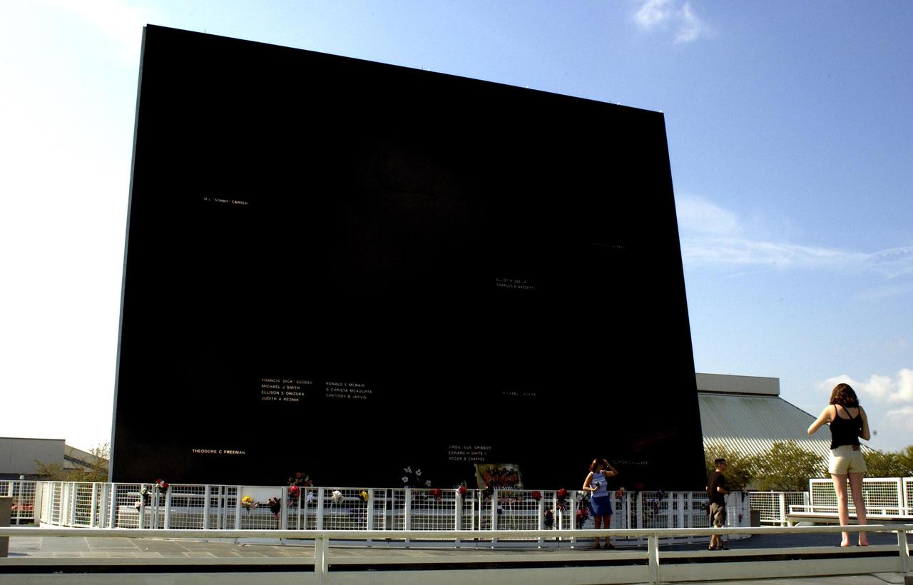 KENNEDY SPACE CENTER, FLA. -   The Astronaut Memorial Space Mirror at the KSC Visitor Complex.  The memorial is a national tribute to 17 American astronauts who previously gave their lives to the quest to explore space.  Flowers have been left by the public in tribute to the fallen crew of the Columbia tragedy, lost in an explosion Feb. 1, 2003, as they were returning to Earth from mission STS-107.