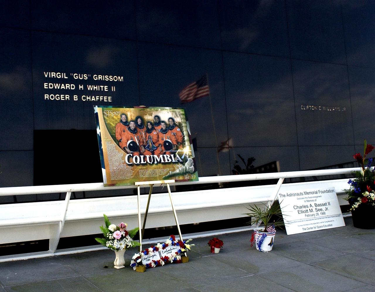 KENNEDY SPACE CENTER, FLA. -  A long view of the Astronaut Memorial Space Mirror at the KSC Visitor Complex.  Flowers have been left by the public in tribute to the fallen crew of the Columbia tragedy, lost in an explosion Feb. 1, 2003, as they were returning to Earth from mission STS-107.  The memorial is a national tribute to 17 American astronauts who previously gave their lives to the quest to explore space.
