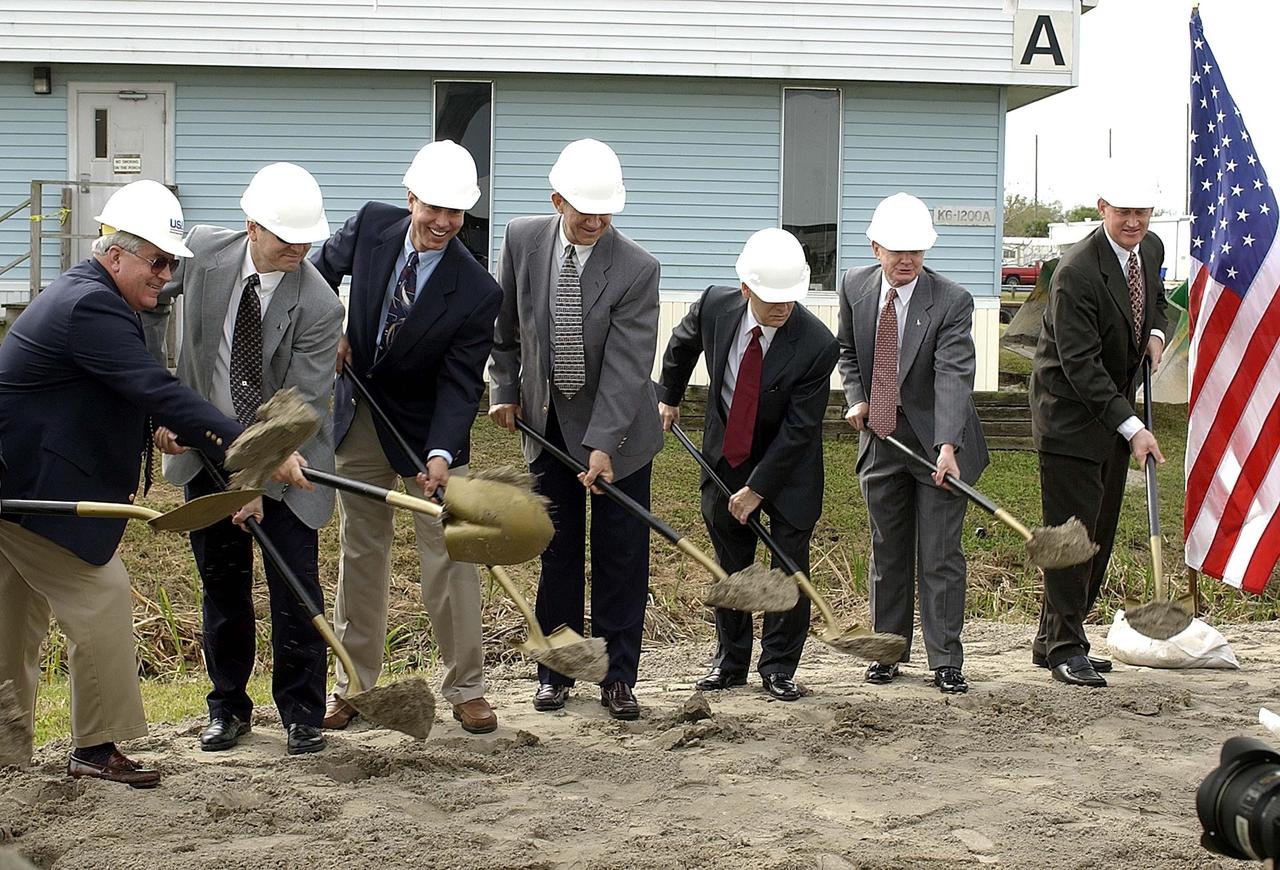KENNEDY SPACE CENTER, FLA. -- -- Lifting their shovels for the groundbreaking of the Operations Support Building II are (left to right) Bill Pickavance, Vice President & Deputy Program Manager Florida Operations, United Space Alliance; Mike Wetmore, director of Shuttle Processing; Miguel Morales, chief, Facilities Division, Spaceport Services; Mike Sumner, chief of operations, Spaceport Services; David Wolfberg, designer of the facility, with Architect and Engineers Wolfberg, Alvarez and Partners of Coral Gables; Roy Bridges, KSC director; and Don Minderman, OSB II project manager, Spaceport Services.  Not shown:  David Boland, David Boland Inc.(construction company). The new building will replace modular housing constructed more than 20 years ago and house NASA and contractor support staff for shuttle operations.  The demolition of the modular buildings has begun and construction will immediately follow.  The new structure is projected to be ready in April 2005.