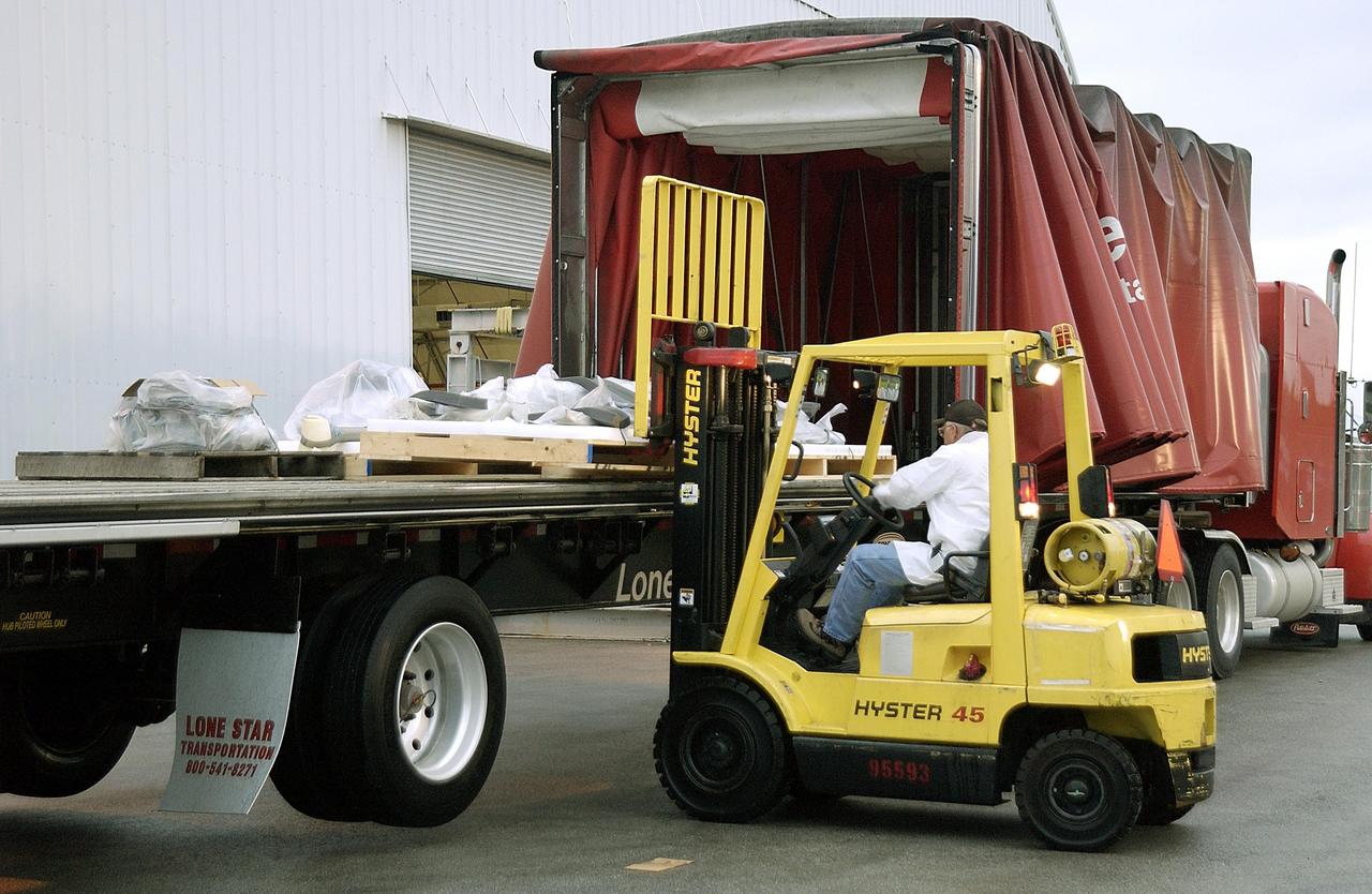 KENNEDY SPACE CENTER, FLA. --  Another shipment of Columbia debris is offloaded at the KSC RLV Hangar after transport from Barksdale AFB, Shreveport, La.  Barksdale continues to be the receiving and shipping point for Columbia materials being sent to KSC for final identification.  Inside the RLV Hangar, the Columbia Reconstruction Project Team will attempt to reconstruct the orbiter as part of the investigation into the accident that caused the destruction of Columbia and loss of its crew as it returned to Earth on mission STS-107.