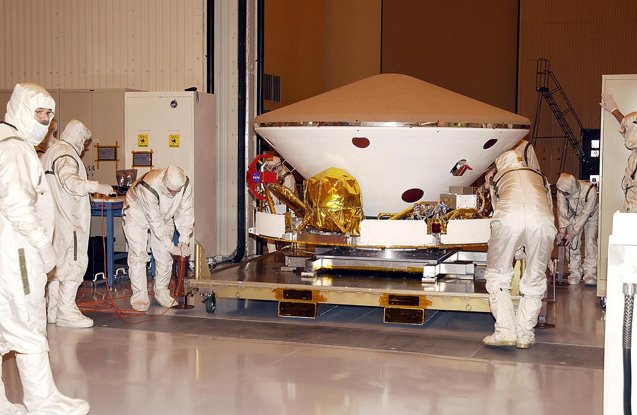 KENNEDY SPACE CENTER, FLA. - Workers in the Payload Hazardous Servicing Facility move the aeroshell and cruise stage of one of the Mars Exploration Rovers (MER).  The two rovers, MER-1 and MER-2, aeroshells and landesr will undergo a full mission simulation while at KSC.  All flight elements will then be integrated.  After spin balance testing, each spacecraft will be mated to a solid propellant upper stage booster that will propel it out of Earth orbit.  The rovers will serve as robotic geologists to seek answers about the evolution of Mars, particularly  for a history of water. The rovers will be identical to each other, but will land at different regions of Mars.  Launch of the MER-1 is scheduled for May 30.  MER-2 will follow June 25.