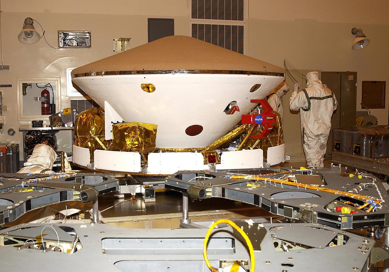 KENNEDY SPACE CENTER, FLA. - In the Payload Hazardous Servicing Facility, elements of one of the Mars Exploration Rovers (MER) come together.  In the foreground is a lander.  In the background are an aeroshell, with the heat shield on top, and cruise stage below. The two rovers, MER-1 and MER-2 , aeroshells and landers will undergo a full mission simulation while at KSC.  All flight elements will then be integrated.  After spin balance testing, each spacecraft will be mated to a solid propellant upper stage booster that will propel it out of Earth orbit.  The rovers will serve as robotic geologists to seek answers about the evolution of Mars, particularly  for a history of water. The rovers will be identical to each other, but will land at different regions of Mars.  Launch of the MER-1 is scheduled for May 30.  MER-2 will follow June 25.