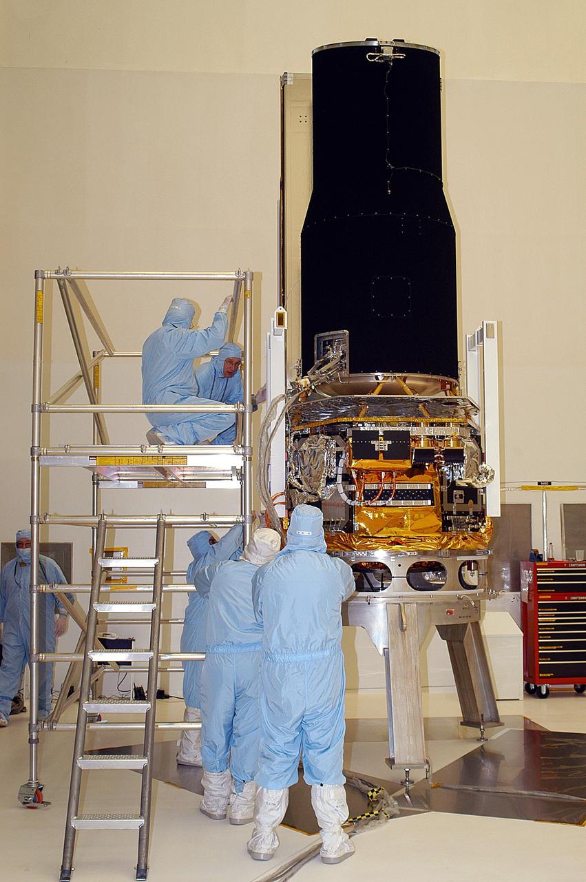 KENNEDY SPACE CENTER, FLA. -- -- At Building AE, the Space Infrared Telescope Facility (SIRTF) is prepared for testing. SIRTF is scheduled for launch aboard a Delta II rocket from Launch Complex 17-B, Cape Canaveral Air Force Station. SIRTF will obtain images and spectra by detecting the infrared energy, or heat, radiated by objects in space.