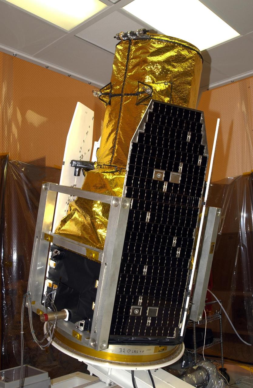 KENNEDY SPACE CENTER, FLA. -- In the Multi-Payload Processing Facility, NASA's Galaxy Evolution Explorer spacecraft is moved to a rotation stand in preparation for mating with the Pegasus XL launch vehicle. The GALEX, set to launch April 2 from Cape Canaveral Air Force Station, will carry into space an orbiting telescope that will observe a million galaxies across 10 billion years of cosmic history to help astronomers determine when the stars and elements we see today had their origins. From its orbit high above Earth, the spacecraft will sweep the skies for 28 months using state-of-the-art ultraviolet detectors.  Looking in the ultraviolet will single out galaxies dominated by young, hot, short-lived stars that give off a great deal of energy at that wavelength.  These galaxies are actively creating stars, and therefore provide a window into the history and causes of star formation in galaxies.