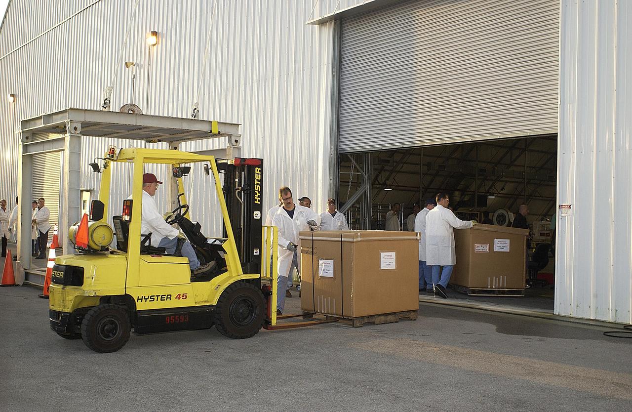KENNEDY SPACE CENTER, FLA. - Boxes of Columbia debris are moved into the KSC RLV Hangar for identification. Inside, the Columbia Reconstruction Project Team is placing the pieces of debris on a floor grid in a configuration of the orbiter. The team will attempt to reconstruct the orbiter as part of the investigation into the accident that caused the destruction of Columbia and loss of its crew as it returned to Earth on mission STS-107.