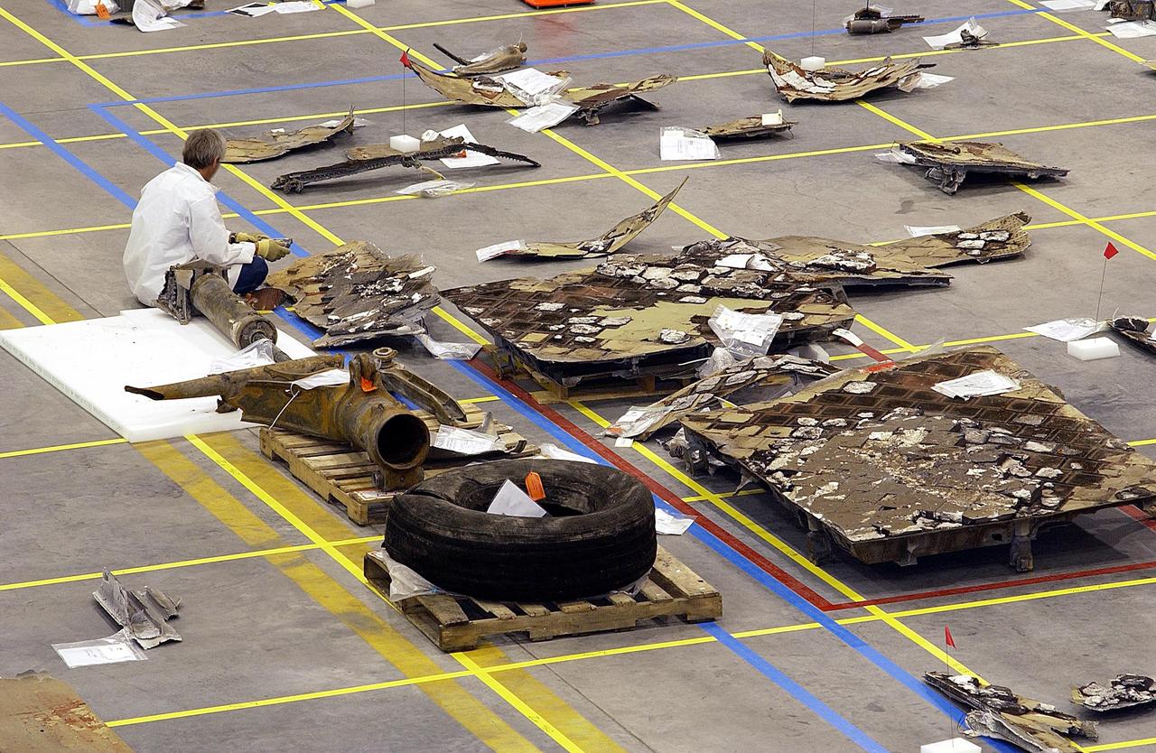 KENNEDY SPACE CENTER, FLA. -  Large pieces of Columbia debris are shown, situated on the floor grid of the KSC RLV Hangar. The Columbia Reconstruction Project Team is attempting to identify the debris and reconstruct the orbiter as part of the investigation into the accident that caused the destruction of Columbia and loss of its crew as it returned to Earth on mission STS-107.