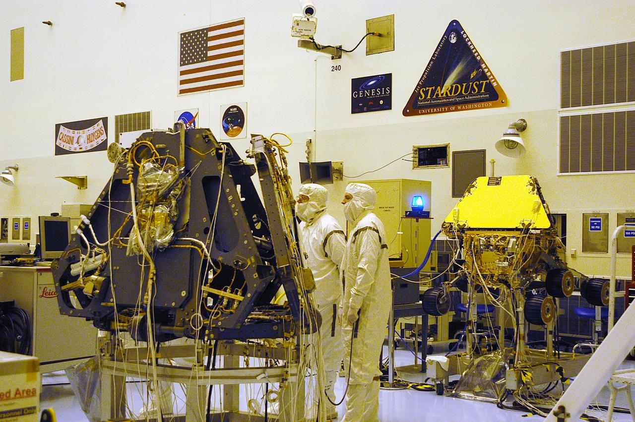 Technicians in the Payload Hazardous Servicing Facility look over the Mars Exploration Rover -2. MER-1 and MER-2, their aeroshells and landers will undergo a full mission simulation before being integrated. After spin balance testing, each spacecraft will be mated to a solid propellant upper stage booster that will propel the spacecraft out of Earth orbit. Approximately 10 days before launch they will be transported to the launch pad for mating with their respective Boeing Delta II rockets. The rovers will serve as robotic geologists to seek answers about the evolution of Mars, particularly for a history of water. The rovers are identical to each other, but will land at different regions of Mars. Launch of the first rover is scheduled for May 30 from Cape Canaveral Air Force Station. The second will follow June 25.