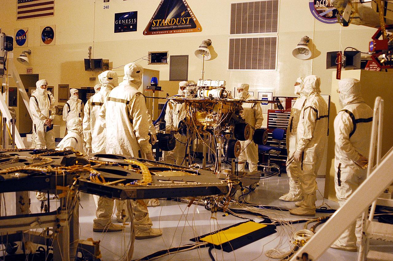 KENNEDY SPACE CENTER, Fla. -  Workers in the Payload Hazardous Servicing Facility observe as one of the two Mars Exploration Rovers, MER-2, undergoes testing.  MER-1 and MER-2, their aeroshells and landers will undergo a full mission simulation before being integrated. After spin balance testing,  each spacecraft will be mated to a solid propellant upper stage booster that will propel the spacecraft out of Earth orbit. Approximately 10 days before launch they will be transported to the launch pad for mating with their respective Boeing Delta II rockets. The rovers will serve as robotic geologists to seek answers about the evolution of Mars, particularly  for a history of water. The rovers are identical to each other, but will land at different regions of Mars.  Launch of the first rover is scheduled for May 30 from Cape Canaveral Air Force Station.  The second will follow June 25.