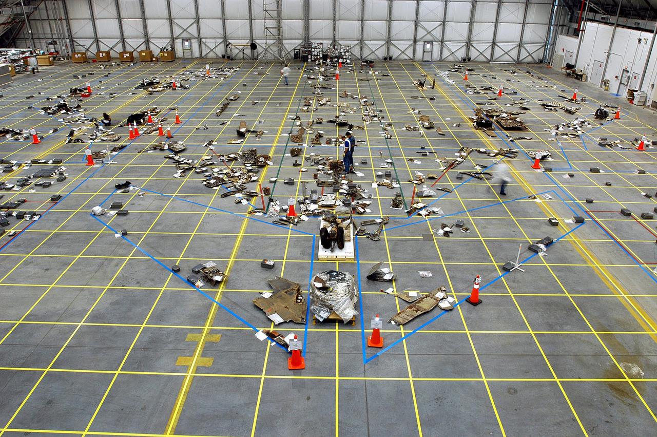 KENNEDY SPACE CENTER, FLA. --  An overview of the RLV Hangar floor shows pieces of Columbia that have been identified and placed within the outline of the orbiter.  The Columbia Reconstruction Project Team is attempting to reconstruct the bottom of the orbiter as part of the investigation into the accident that caused the destruction of Columbia and loss of its crew as it returned to Earth on mission STS-107.