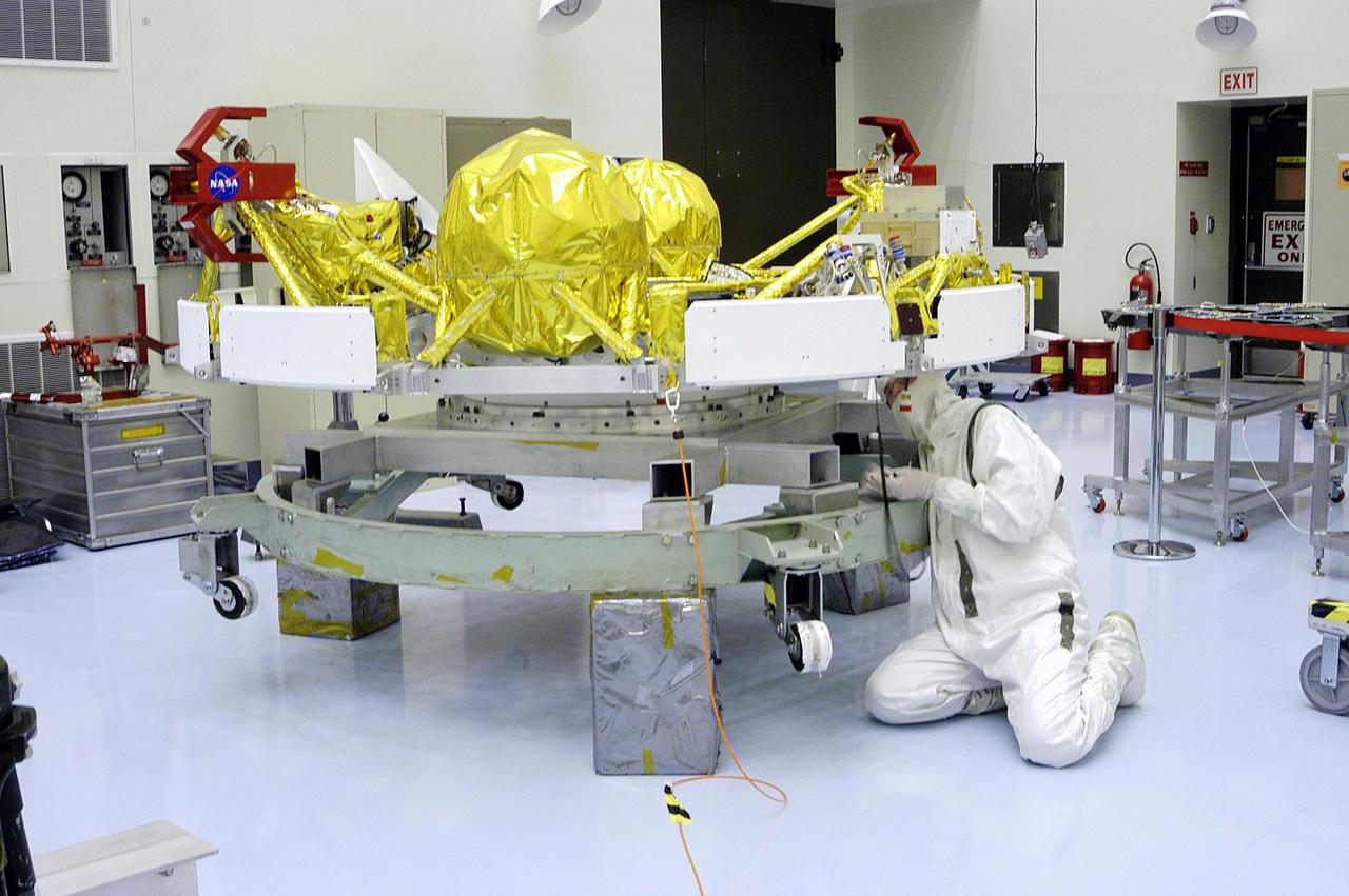 KENNEDY SPACE CENTER, Fla. - A technician in the Payload Hazardous Servicing Facility works on the cruise stage of one of the Mars Exploration Rovers (MER).  MER-1 and MER-2, their aeroshells and landers will undergo a full mission simulation before being integrated. After spin balance testing,  each spacecraft will be mated to a solid propellant upper stage booster that will propel the spacecraft out of Earth orbit. Approximately 10 days before launch they will be transported to the launch pad for mating with their respective Boeing Delta II rockets. The rovers will serve as robotic geologists to seek answers about the evolution of Mars, particularly  for a history of water. The rovers are identical to each other, but will land at different regions of Mars.  Launch of the first rover is scheduled for May 30 from Cape Canaveral Air Force Station.  The second will follow June 25.