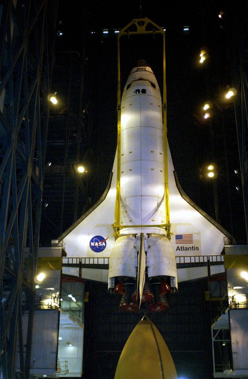KENNEDY SPACE CENTER, FLA. - Atlantis is lifted up and away from the orange external tank after demating.  The orbiter will be lifted out of the high bay in the Vehicle Assembly Building and lowered into the transfer aisle.  Atlantis will then be moved to the Orbiter Processing Facility.