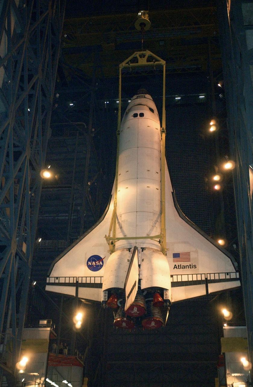 KENNEDY SPACE CENTER, Fla. - Atlantis is lowered toward the floor of the transfer aisle in the Vehicle Assembly Building.   After demating from its external tank, Atlantis was lifted out of the high bay to the transfer aisle.  Atlantis will now be moved to the Orbiter Processing Facility.