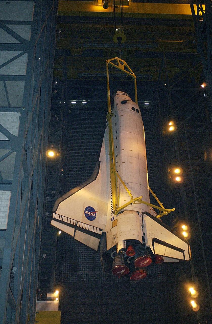 KENNEDY SPACE CENTER, Fla. - Atlantis is lowered toward the floor of the transfer aisle in the Vehicle Assembly Building.   After demating from its external tank, Atlantis was lifted out of the high bay to the transfer aisle.  Atlantis will now be moved to the Orbiter Processing Facility.